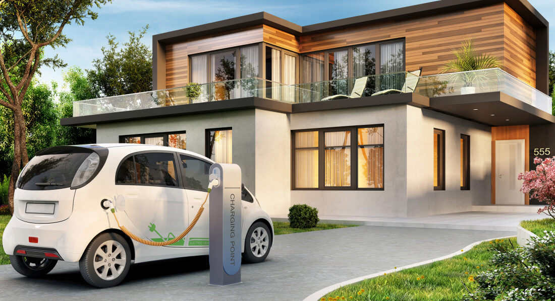 An electric car charging at a modern home