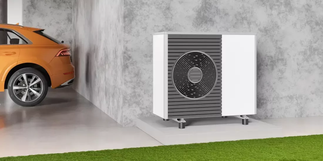 CGI of a modern heat pump installed against a grey building with an orange vehicle in the background
