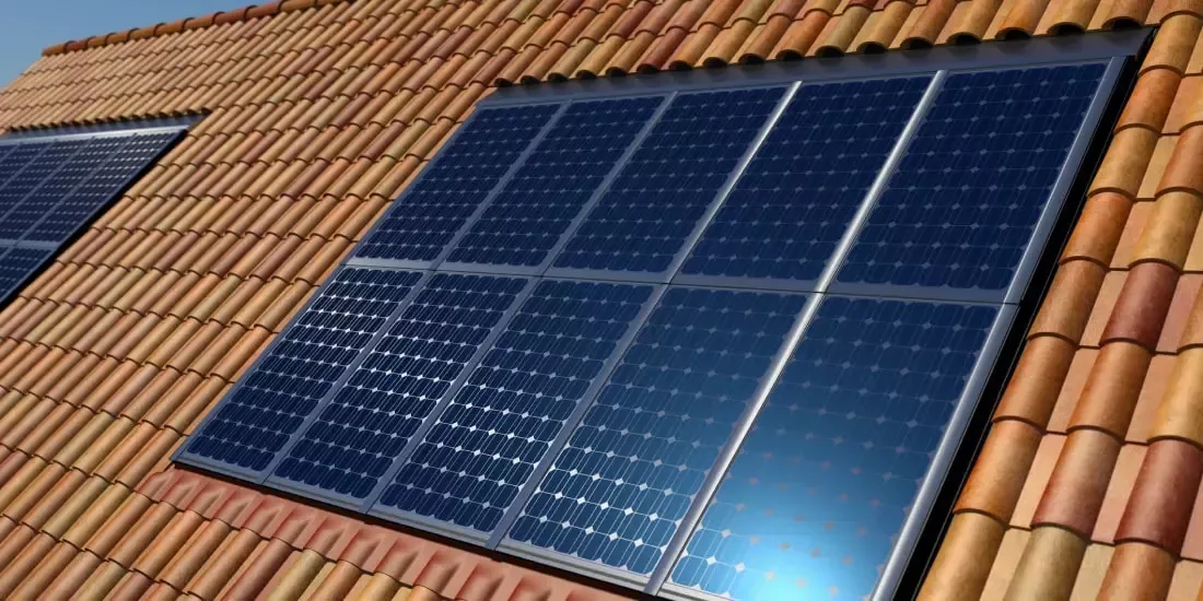 Solar panels integrated into a roof against brown roof tiles