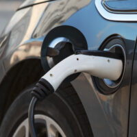 Electric car plugged in and charging 204986854