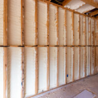 Wall in new home under construction with spray foam insulation