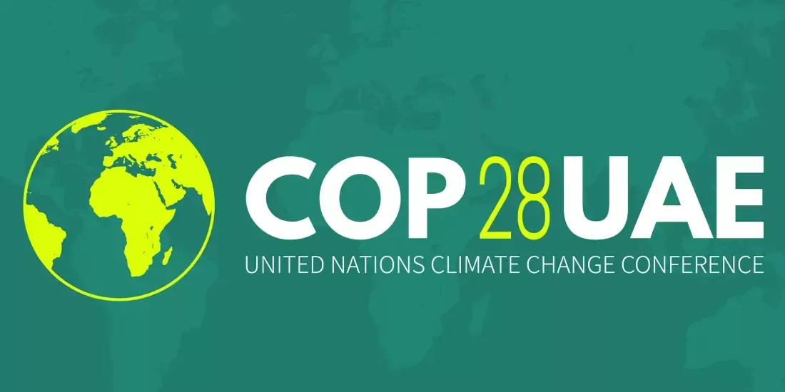 COP28 poster with a dark green background and a light green Earth outline