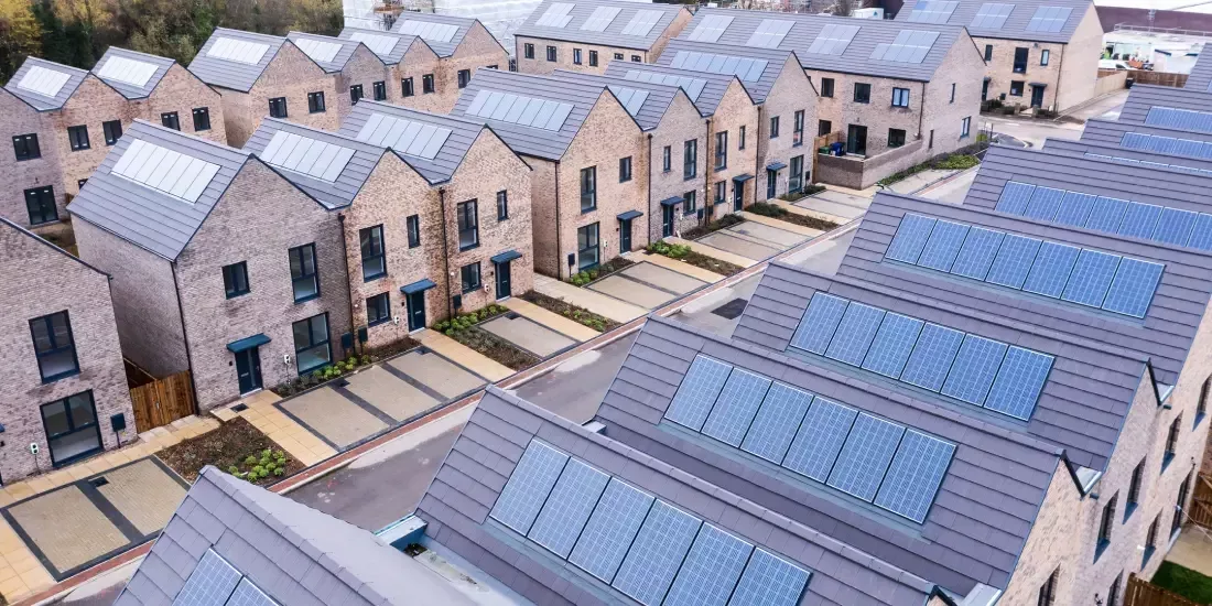 Rows of terraced new build homes with solar panels on their roofs