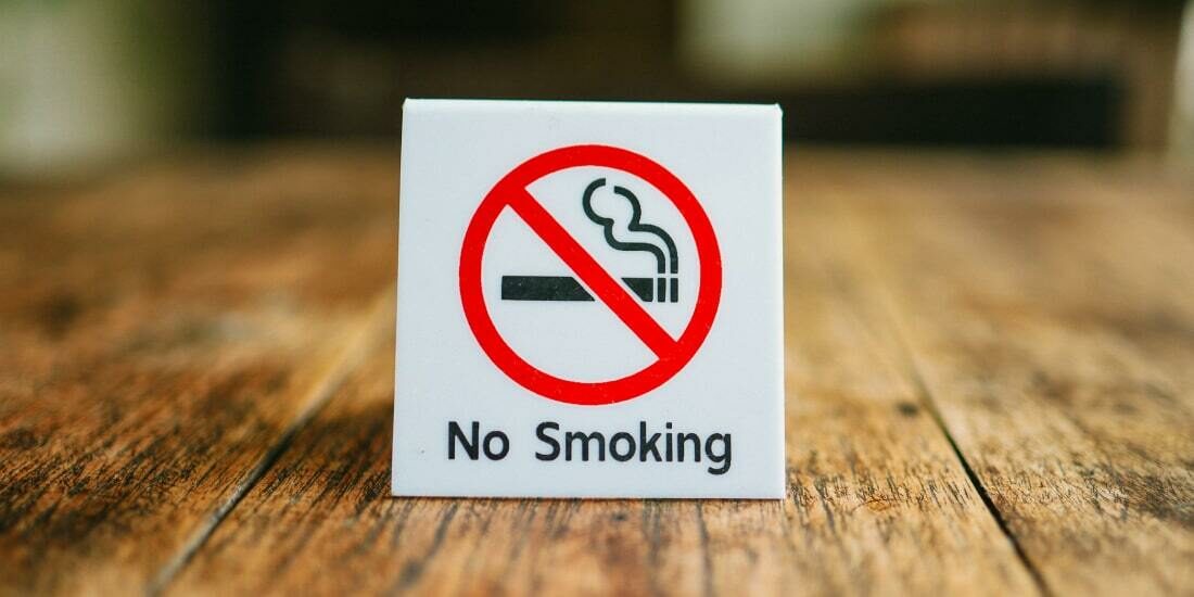 A no smoking sign on a wooden table