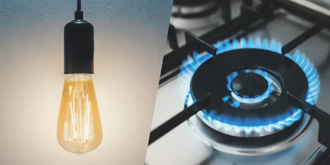 A downlight bulb on one side with a lit gas hob on the other