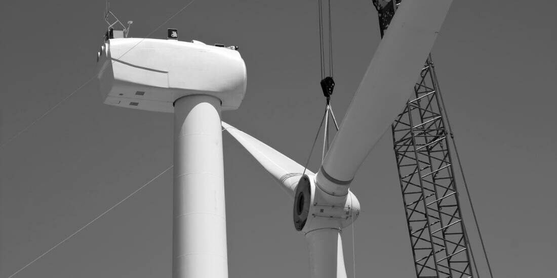 The blades of a wind turbine being connected via crane